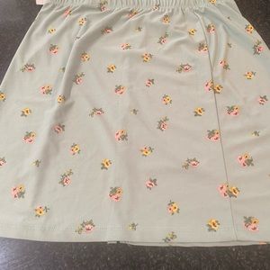 Women’s blue floral  mini skirt. It has a slit on the front.